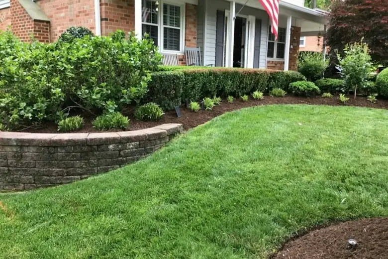 Example placeholder, not E&P's work: planted beds above a block wall
